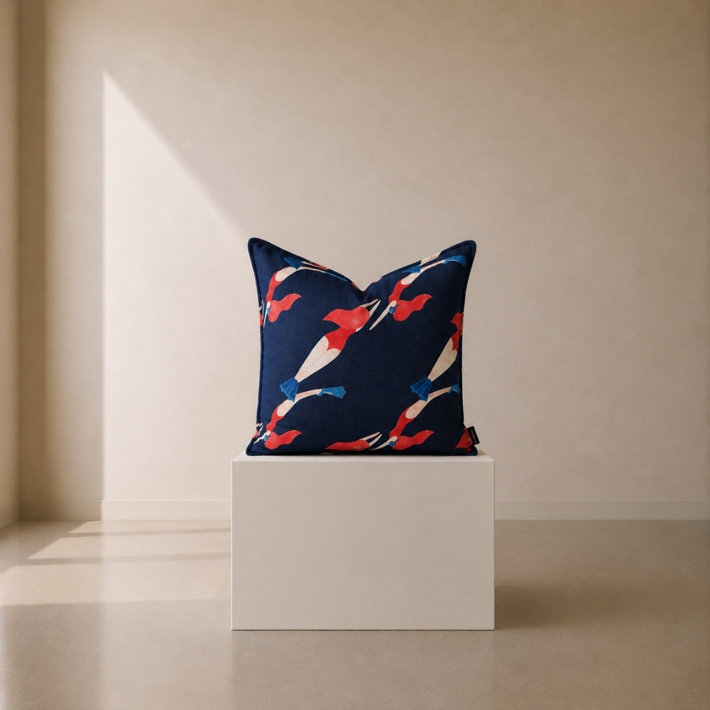 Deep Dive Scatter Cushion featuring an abstract print of swimmers in red, white, and blue against a deep navy background.