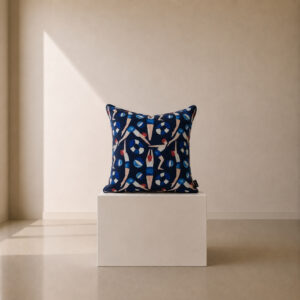 Decorative scatter cushion featuring an illustrated pattern of swimmers, beach balls, and lifebuoys on a deep navy background with vibrant blue, white, and coral accents.